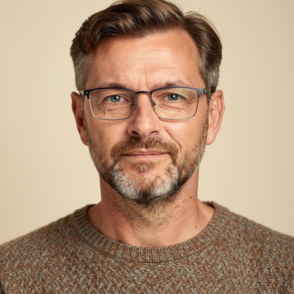 Studio portrait of a Swiss advertising archivist in his forties